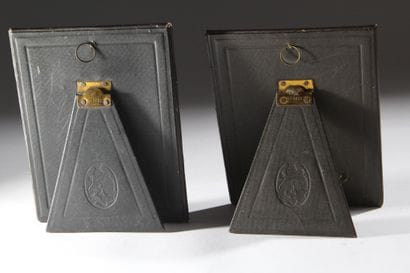 A pair of photo frames with leather borders...