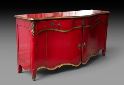 A red-lacquered wooden sideboard with gold...