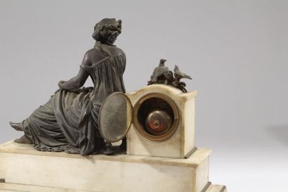 Bronze and white marble clock decorated with...