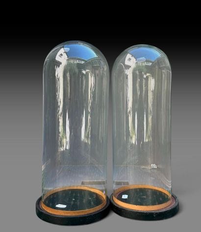 A set of two cylindrical glass globes and...