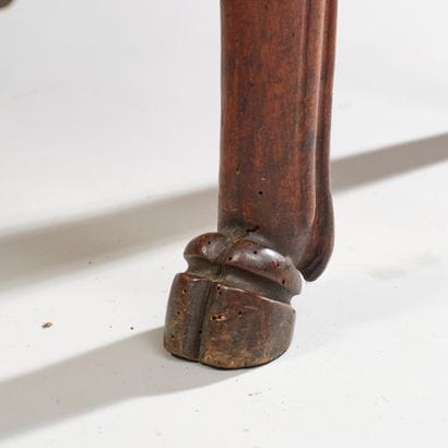 Carved wooden armchair with a curved, crook-shaped...