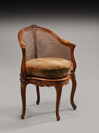 Cane-seated office chair made of molded and...