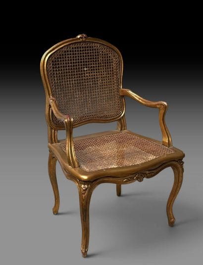 A wooden armchair with molded, carved, and...