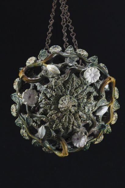 A basket-shaped hanging lamp made of glazed...