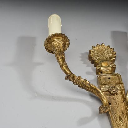 Two-light wall sconce in patinated, gilded,...
