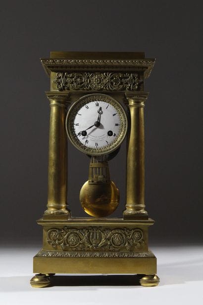 A chiseled and gilded bronze four-column...