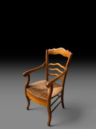 Rustic wooden armchair with a straw seat.
Louis...