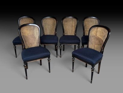 A set of six chairs made of black-painted...