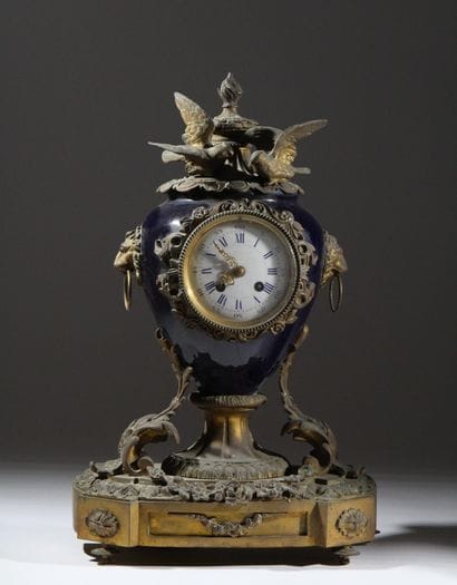 Bronze and metal clock with a case shaped...