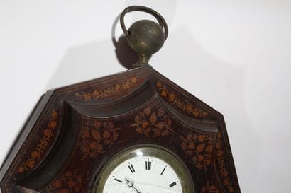 A wooden wall-mounted sign, known as an “ox-eye,”...