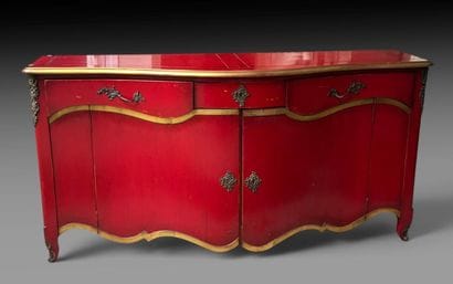 A red-lacquered wooden sideboard with gold...