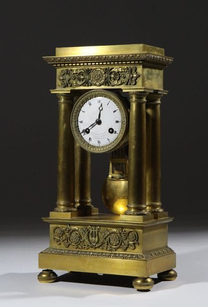 A chiseled and gilded bronze four-column...