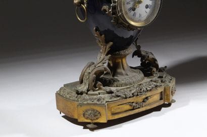 Bronze and metal clock with a case shaped...