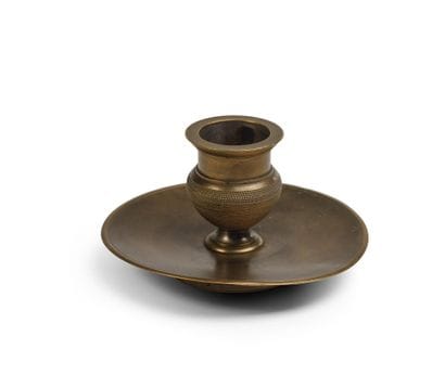 Small bronze torch on a pedestal with a circular...