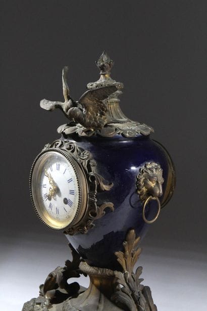 Bronze and metal clock with a case shaped...