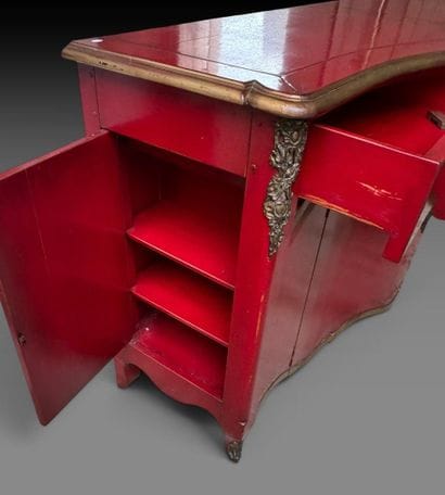 A red-lacquered wooden sideboard with gold...
