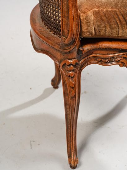 Cane-seated office chair made of molded and...