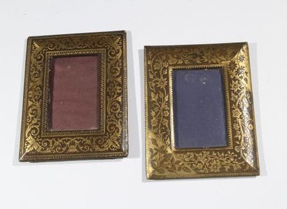 A pair of photo frames with leather borders...