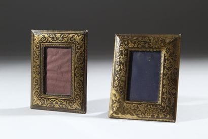 A pair of photo frames with leather borders...