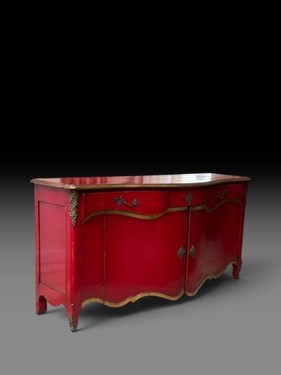 A red-lacquered wooden sideboard with gold...