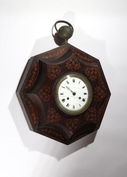 A wooden wall-mounted sign, known as an “ox-eye,”...