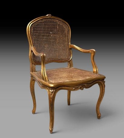A wooden armchair with molded, carved, and...