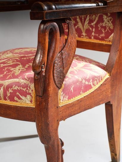 Carved wooden armchair with a curved, crook-shaped...