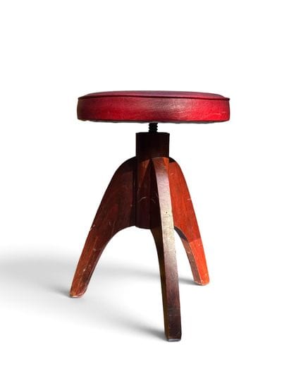 MODERNIST PIECE 
Three-legged walnut stool...