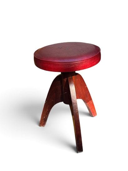 MODERNIST PIECE 
Three-legged walnut stool...