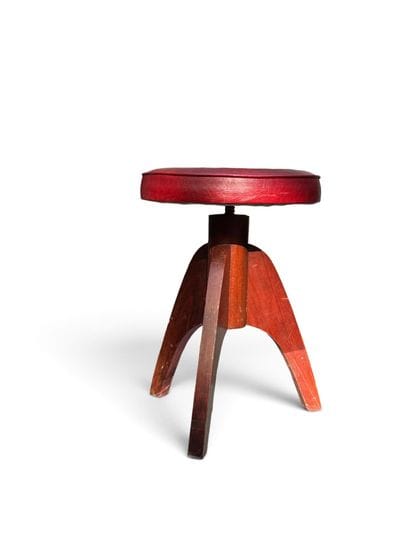 MODERNIST PIECE 
Three-legged walnut stool...
