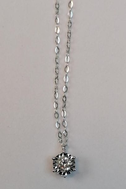 White gold necklace set with a 0.10 ct modern...