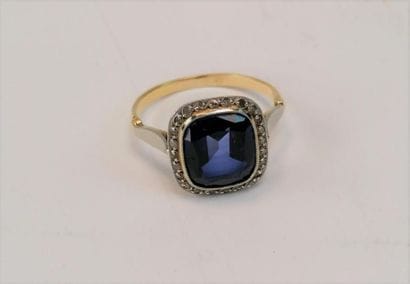 Gold and platinum ring set with a blue stone....