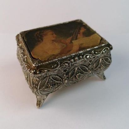 Small jewelry box in silvery metal with flowers...
