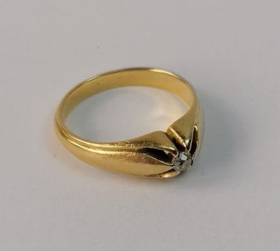 Yellow gold ring decorated with a small diamond....