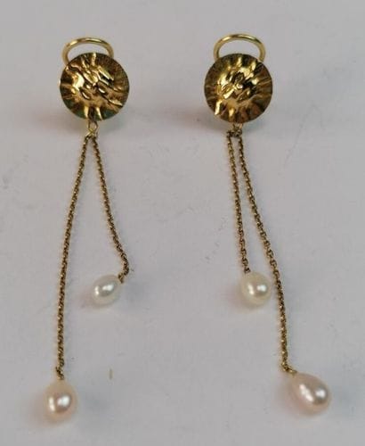 Pair of hanging ear clips in yellow gold...