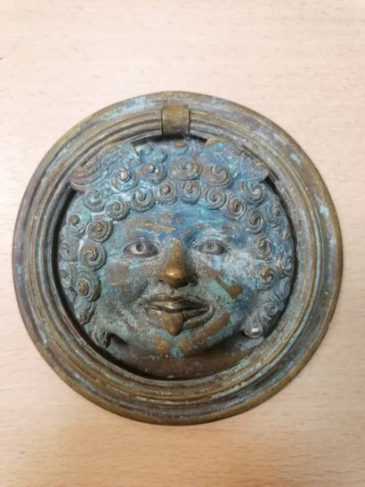 Bronze door knocker representing a grote...