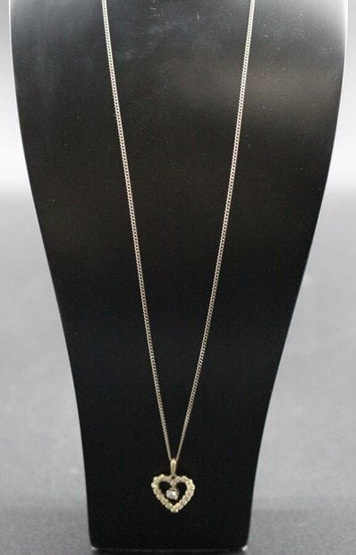 White gold chain with a heart pendant and...