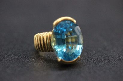 Yellow gold ring set with a large oval topaz...