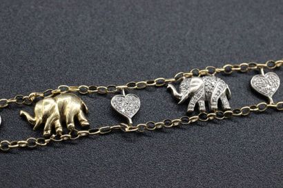 Yellow gold bracelet decorated with charms...