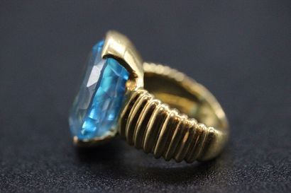 Yellow gold ring set with a large oval topaz...