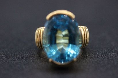 Yellow gold ring set with a large oval topaz...