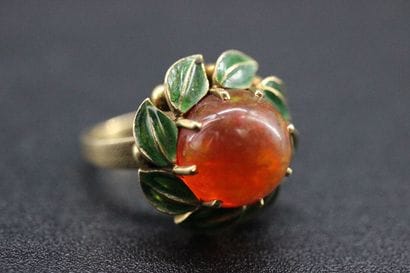 Yellow gold daisy ring set with an orange...