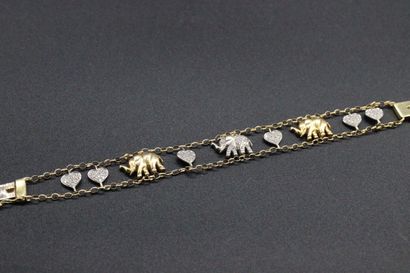 Yellow gold bracelet decorated with charms...