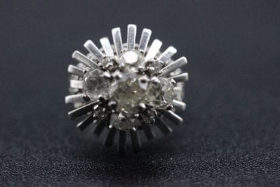 White gold dome ring set with 5 old-cut diamonds....