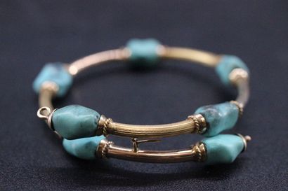 Semi rigid bracelet in yellow gold decorated...
