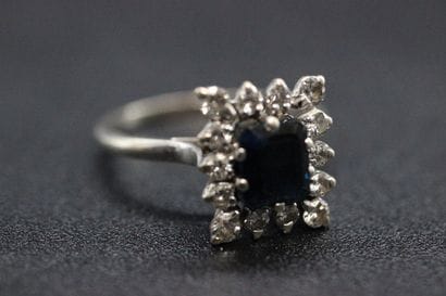White gold daisy ring set with a blue stone...