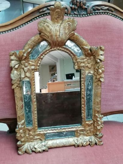 Wood and gilded paste mirror decorated with...