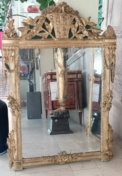 Carved wood mirror decorated with a flower...
