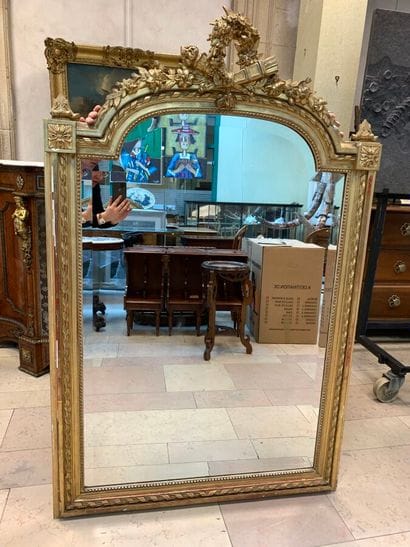 Wood and gilded stucco mirror decorated with...