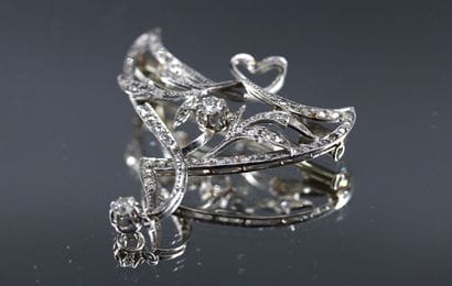 Platinum brooch with foliate decoration set...
